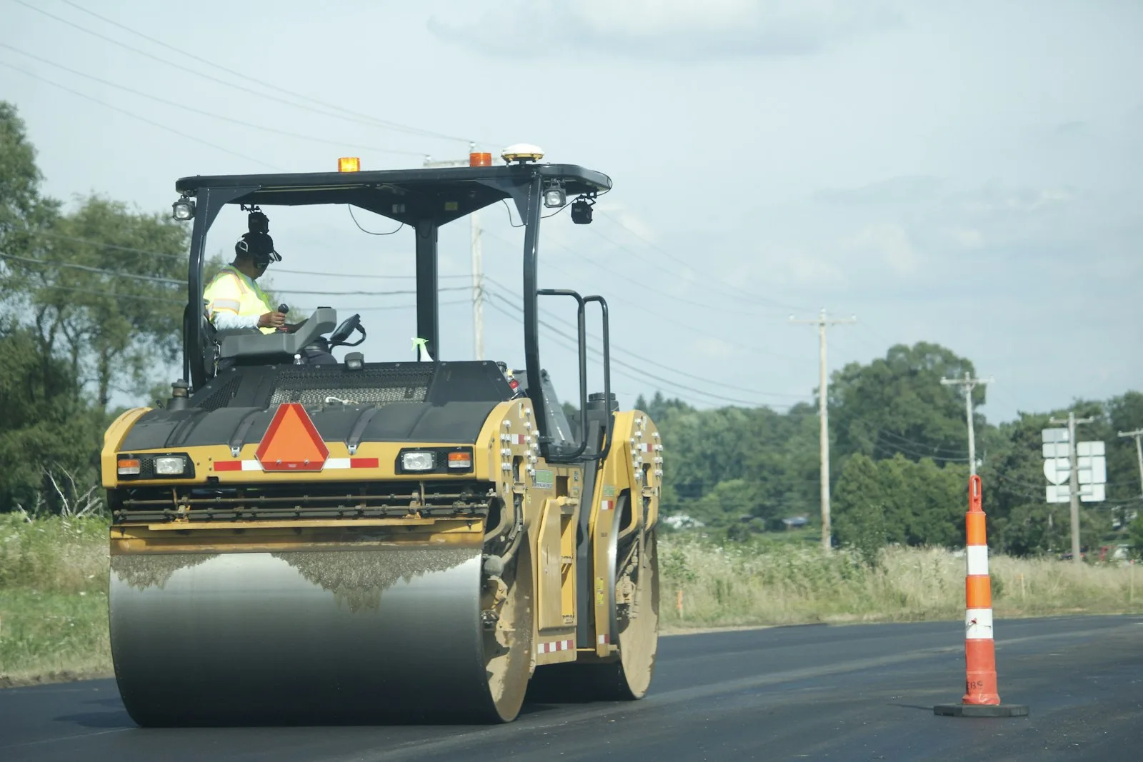 A tandem roller compacting new asphalt on a road
