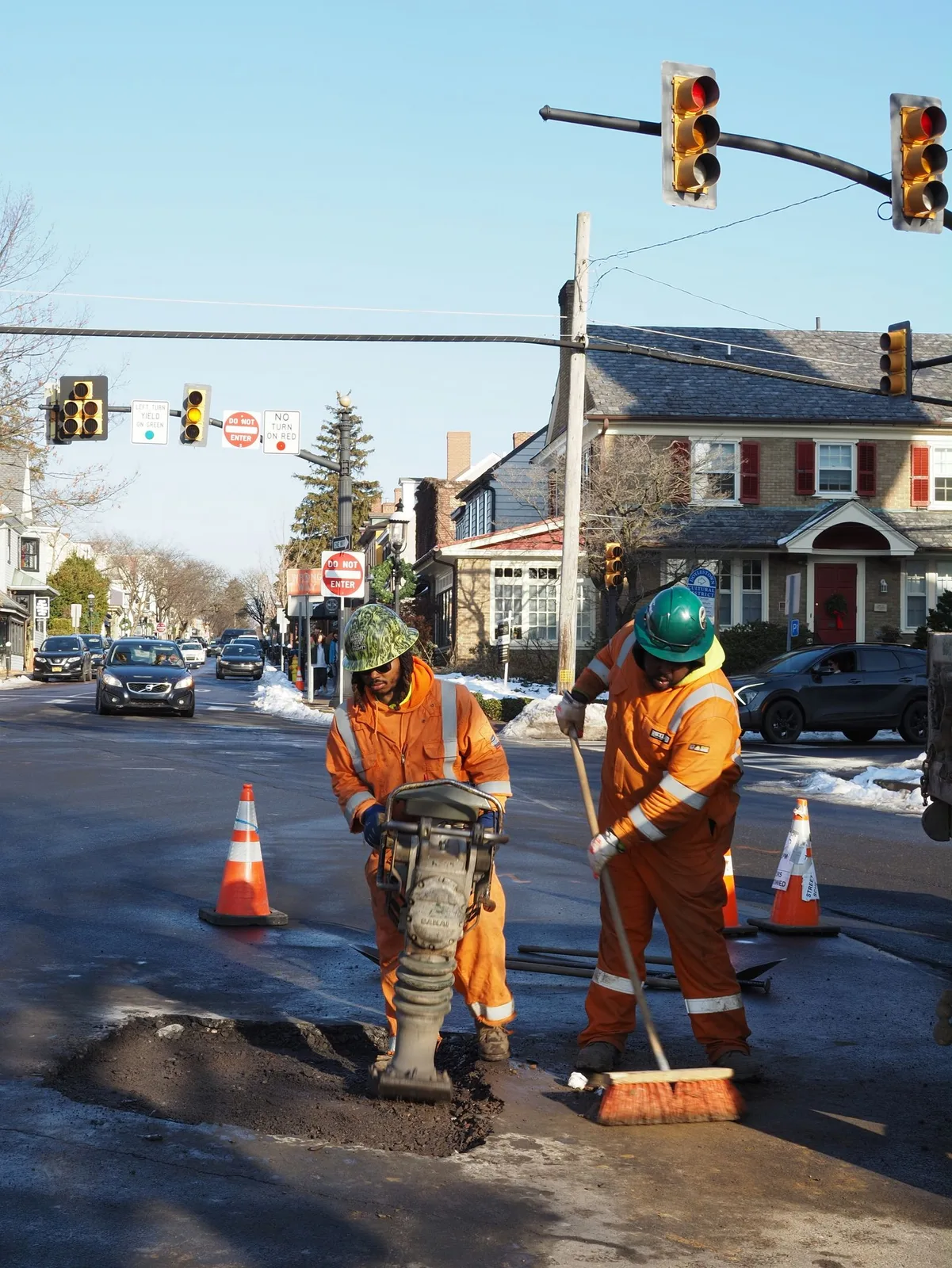A high visibility crew cutting pavement for a street repair